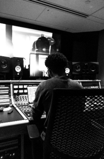 Jyair Washington at the mixing console in a recording studio control room